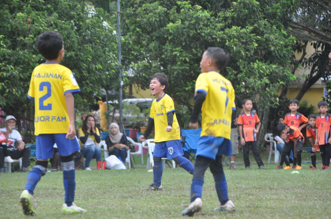 Young JuniorFam players celebrating together